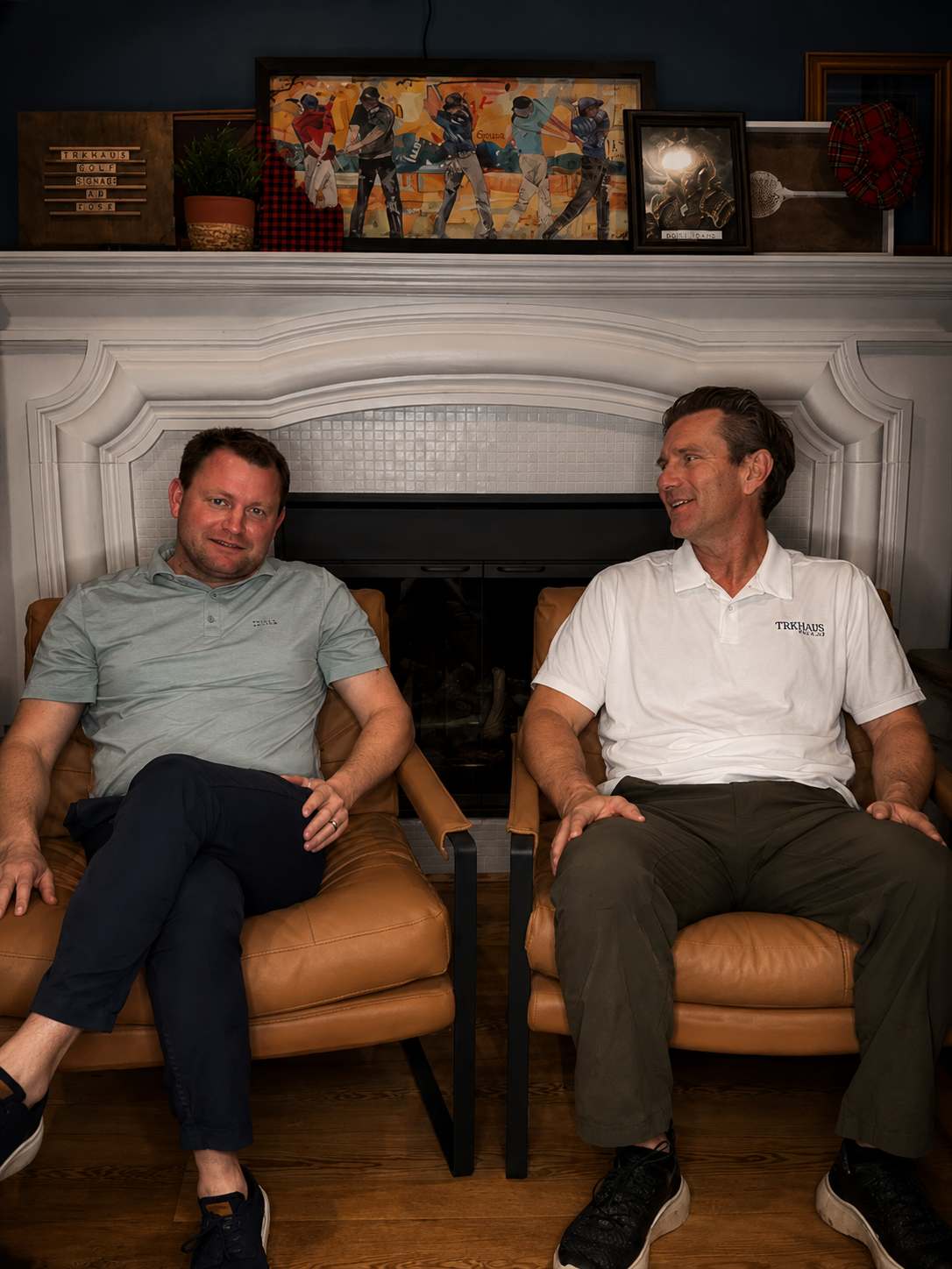Premium lounge seating area inside TrkHaus Golf Club private simulator bay Boise Idaho with Loren and Todd.